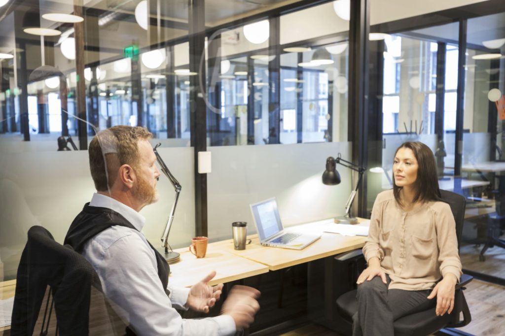 Two professionals in conversation at a modern office